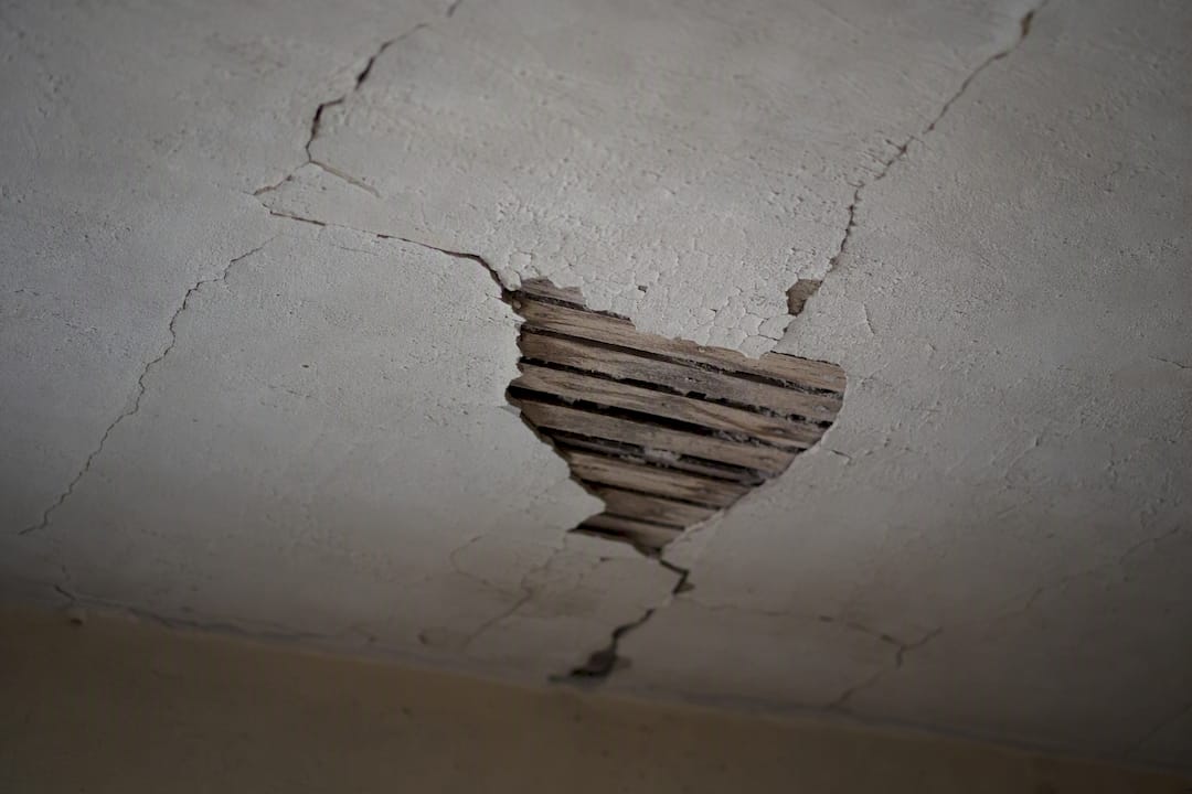 Close-up of cracked old plaster ceiling surface