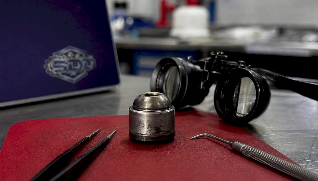 Macro view of diesel injector ball-seat wear from particles
