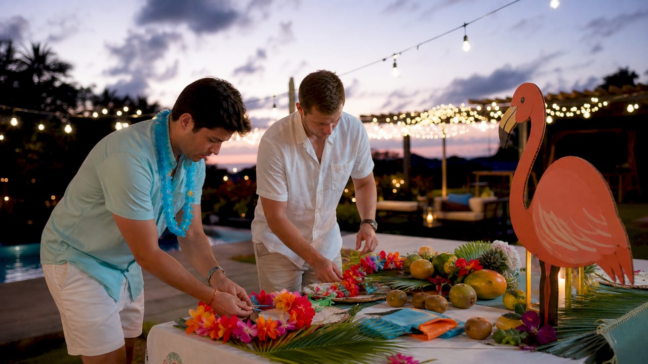 Hands arranging tropical theme party decor