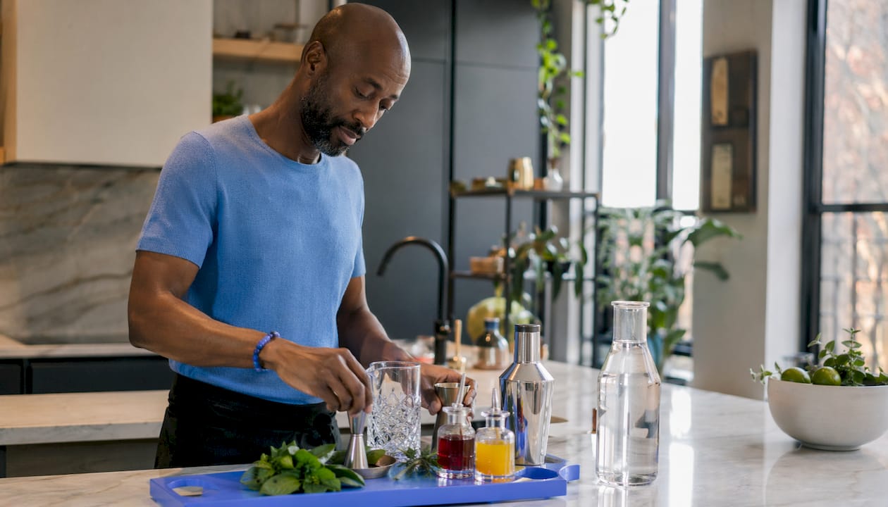 Hands preparing cocktail kit at home bar