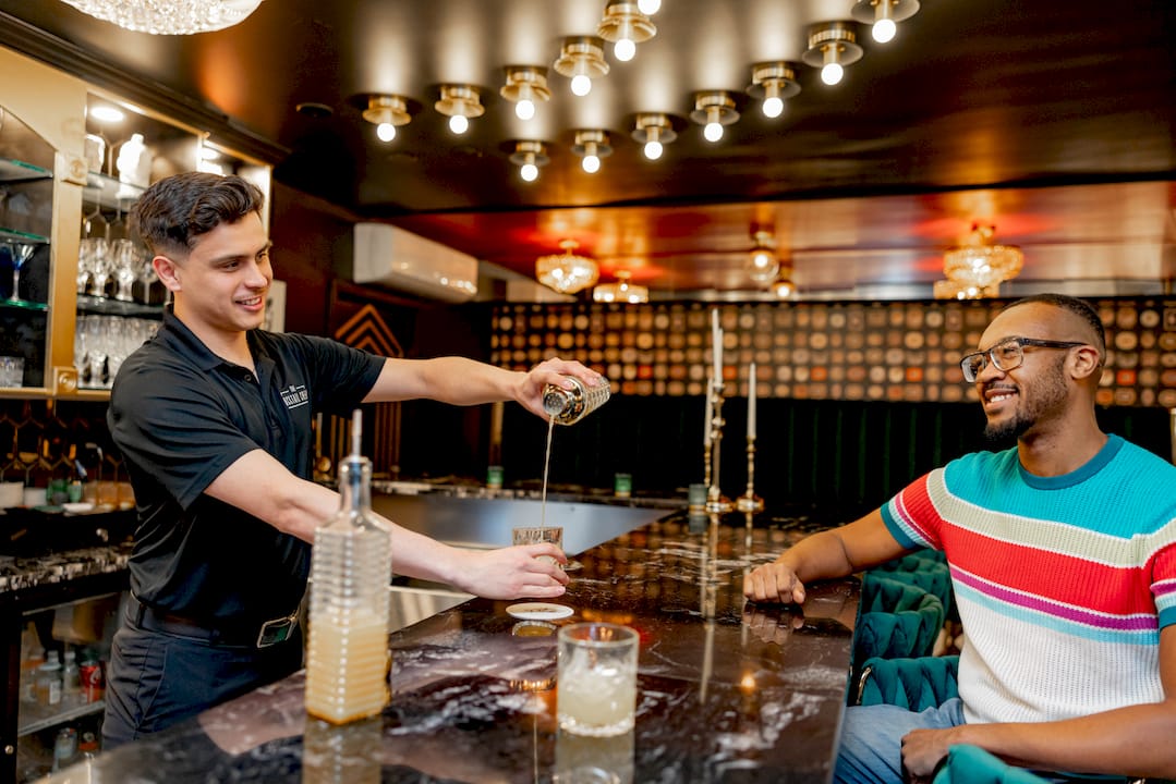 Bartender serving cocktail at outdoor private party