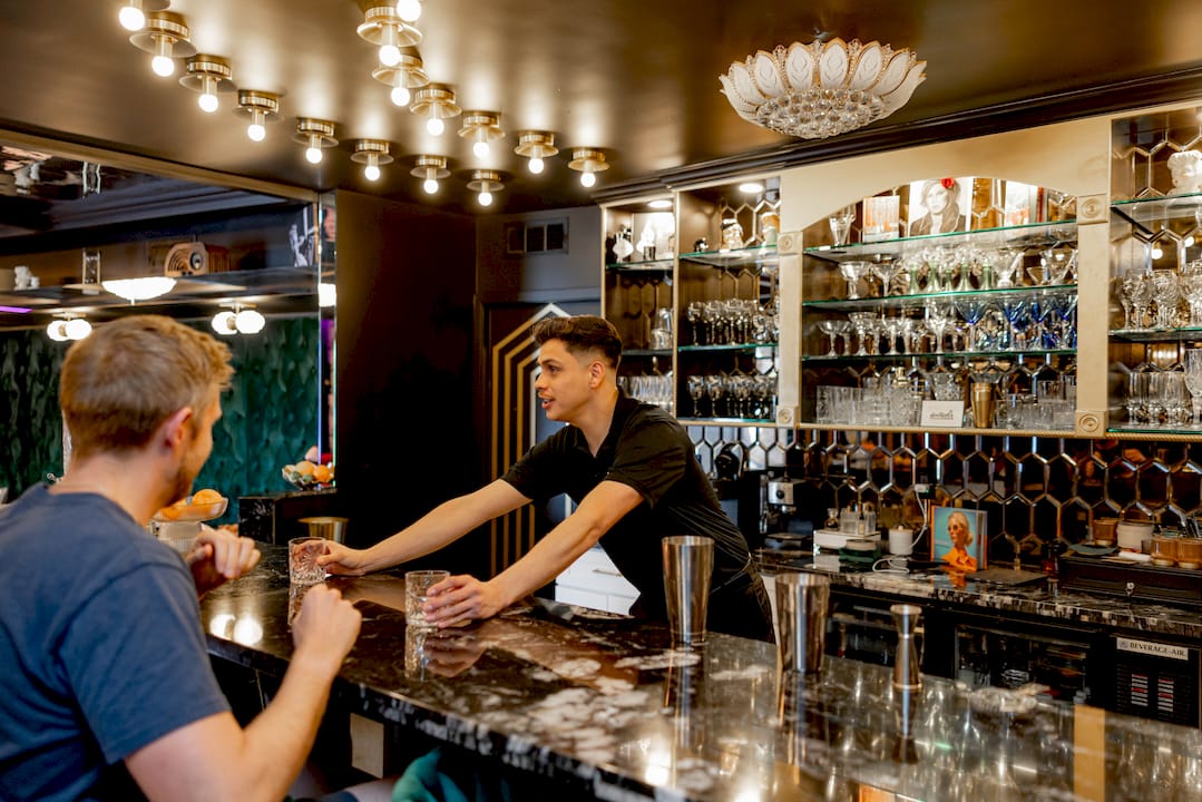 Bartender making cocktails at interactive station