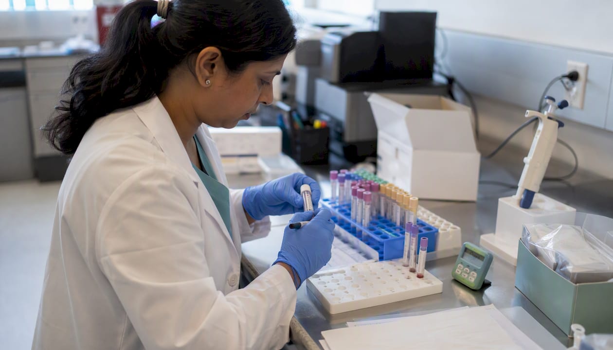 Technician preparing QuantiFERON blood test tubes