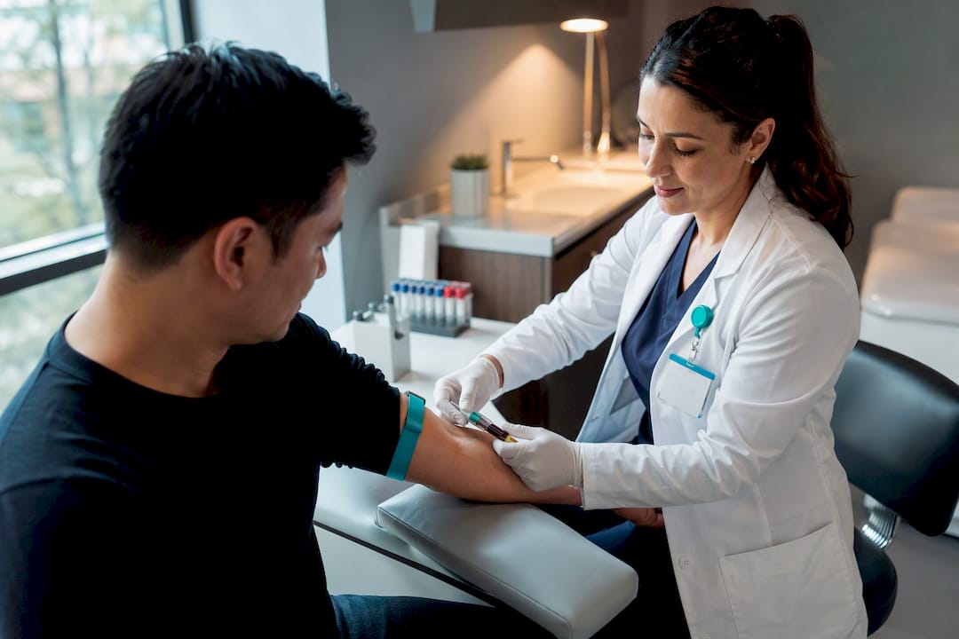 Clinician drawing blood for immigration TB screening