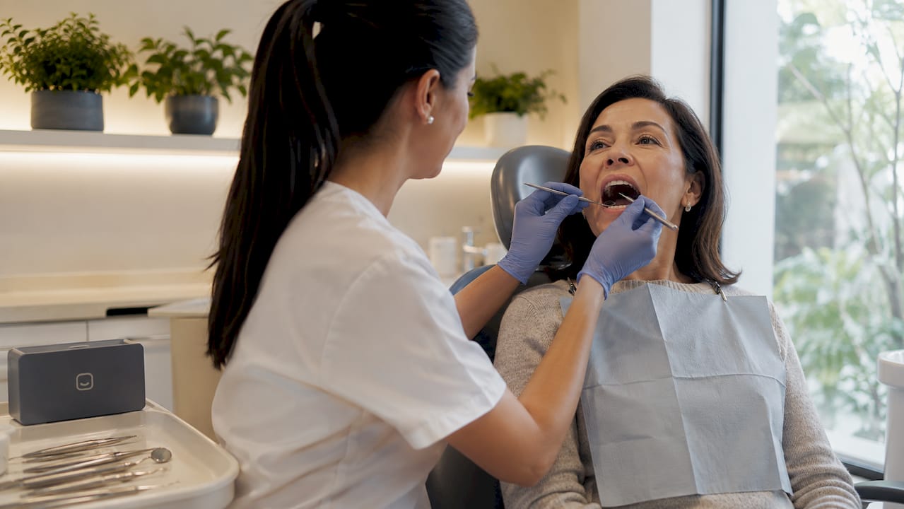 Dentist examining jawbone in denture patient
