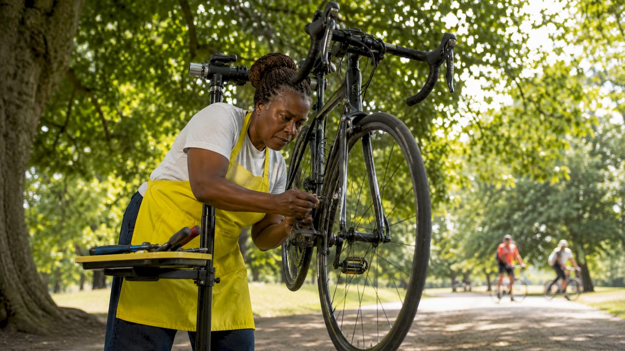 Mechanic inspecting bicycle in bright workshop