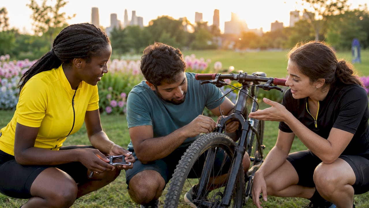 Hands adjusting bike brakes and gears outdoors