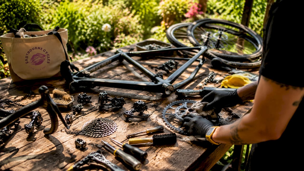 Overhead view of disassembled bike parts laid out on table