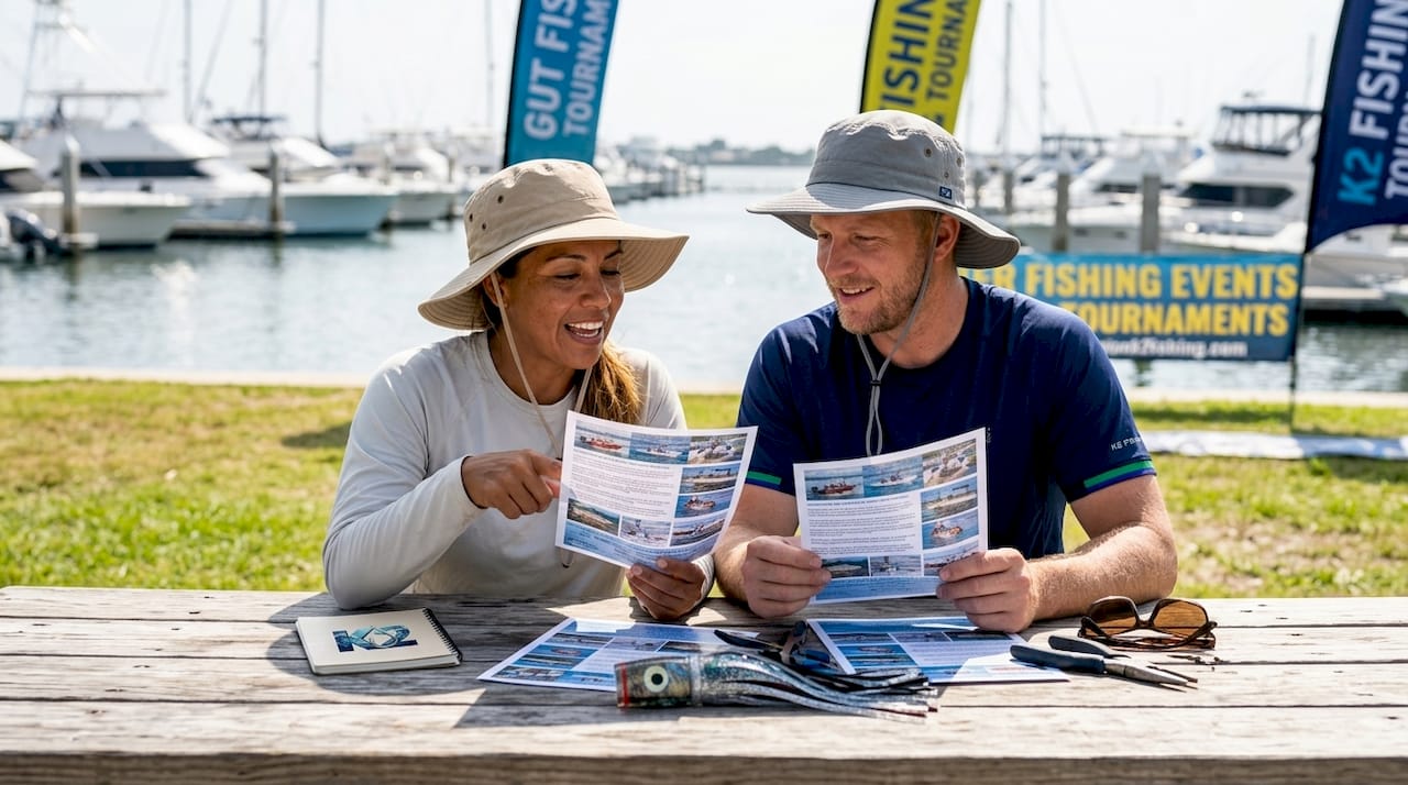 Group reviewing offshore fishing club brochures