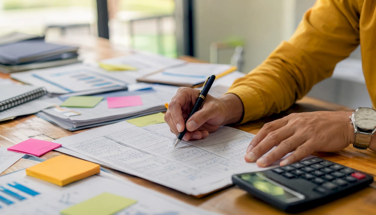 Accountant calculating liquidity ratios at desk