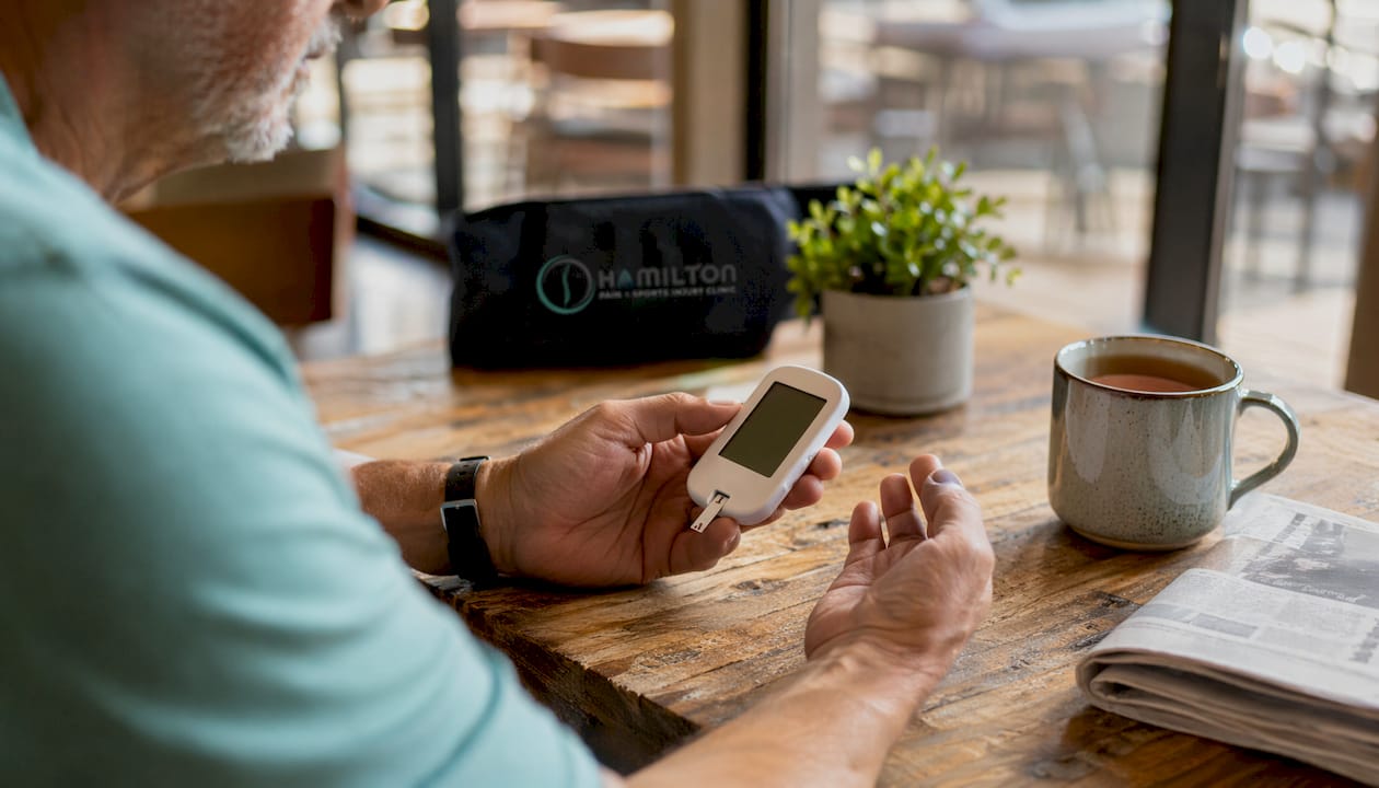 Older adult measuring blood glucose at home