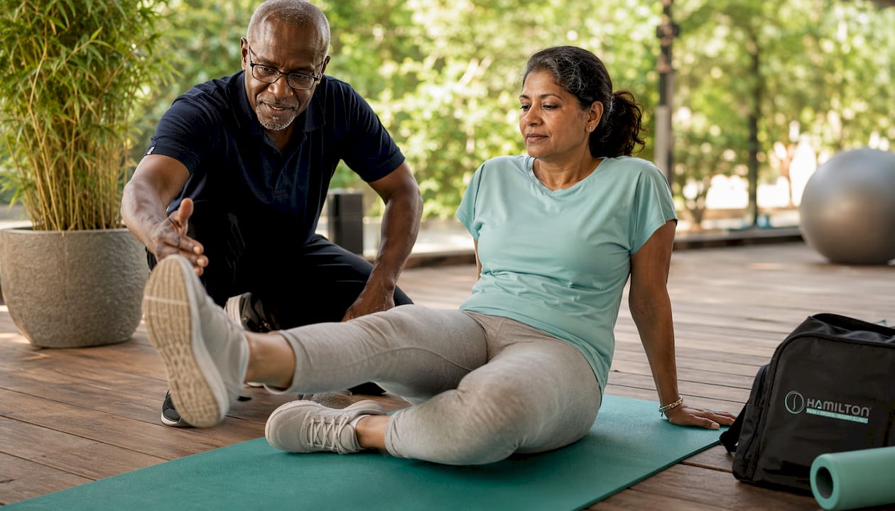 Physiotherapist assisting gentle exercise for injury recovery