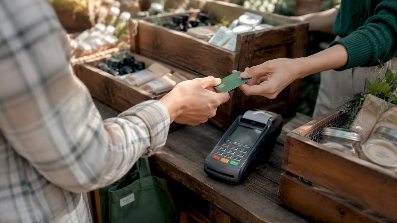 Hands making credit card payment at store counter