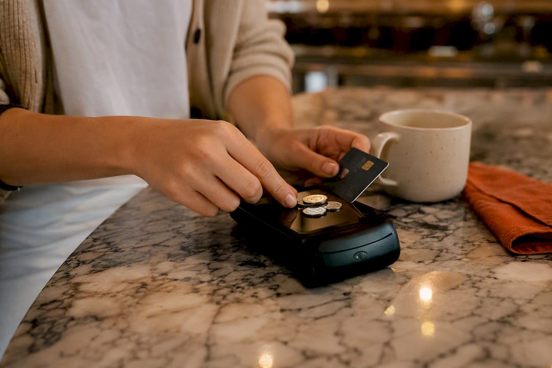 Hands making multiple small credit card payments