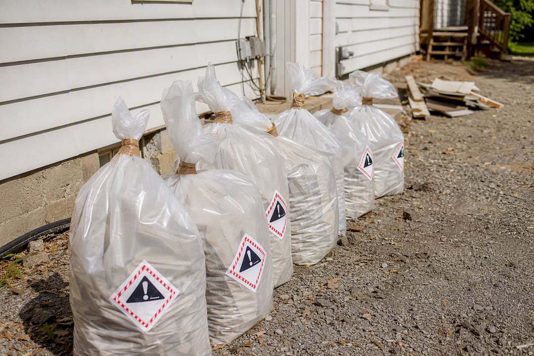 Sealed asbestos siding waste bags outdoors