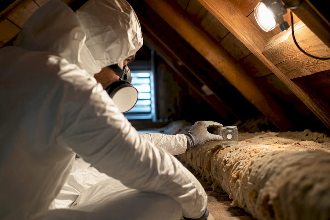 Professional conducting an asbestos air assessment