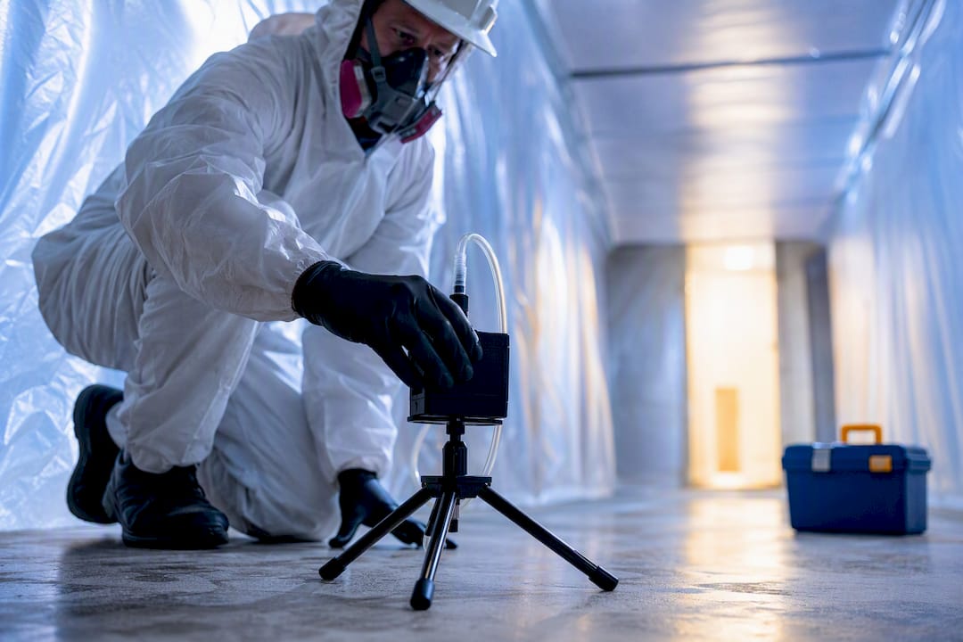 Air sampling cassette inside asbestos containment