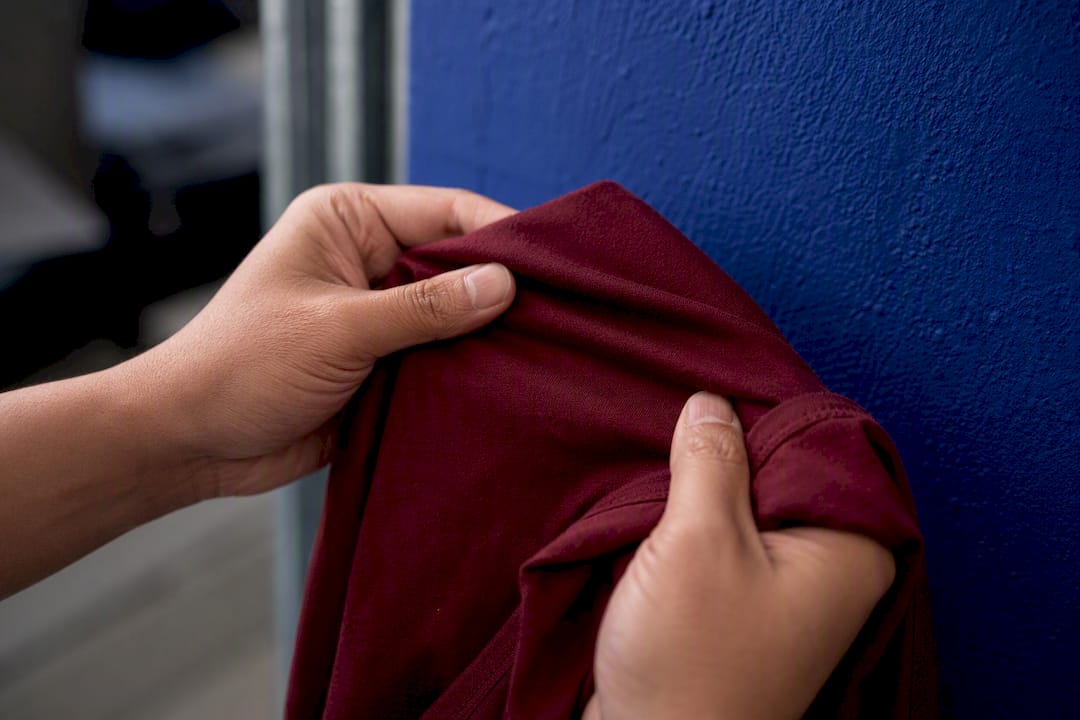 Hands feeling cotton fabric texture