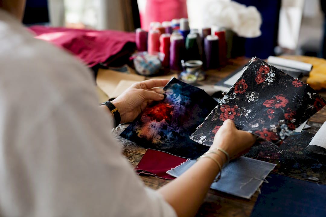 Hands feeling different fabric print textures