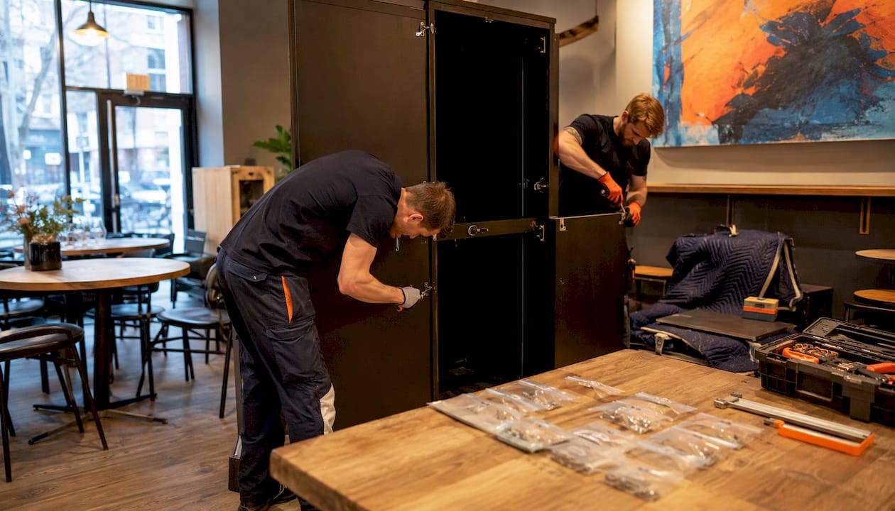 Professional team dismantling wardrobe in home