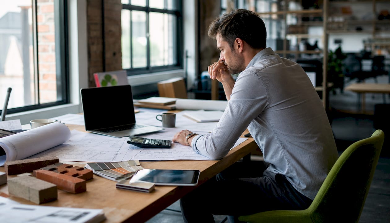 Construction cost estimation tools on desk