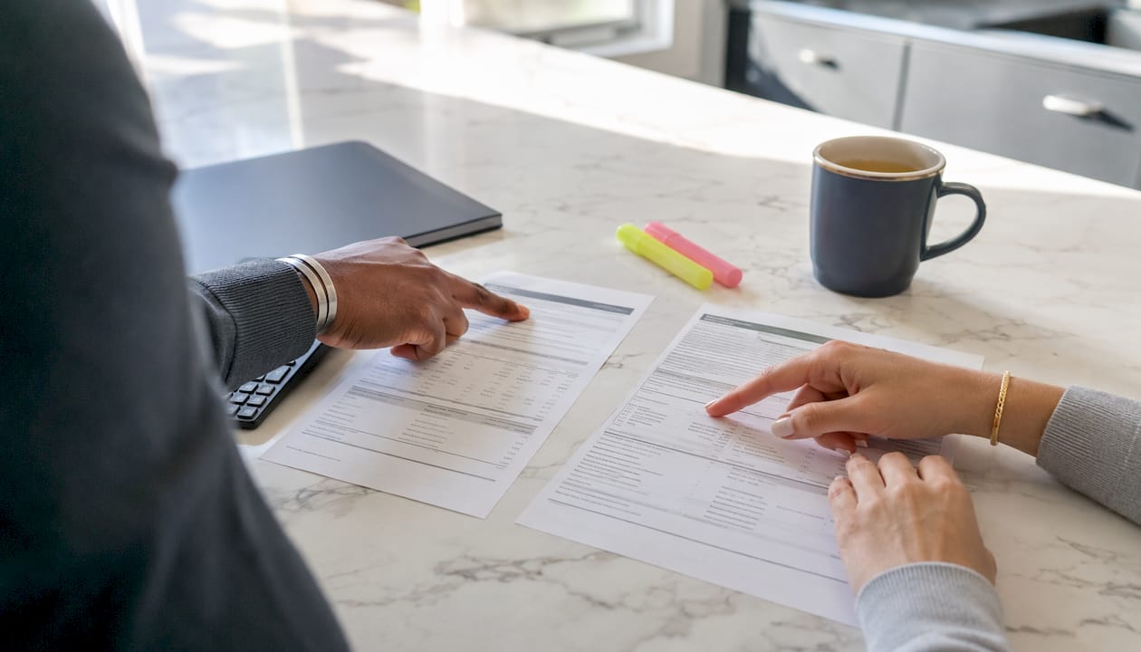 Hands examining HELOC and seller financing paperwork