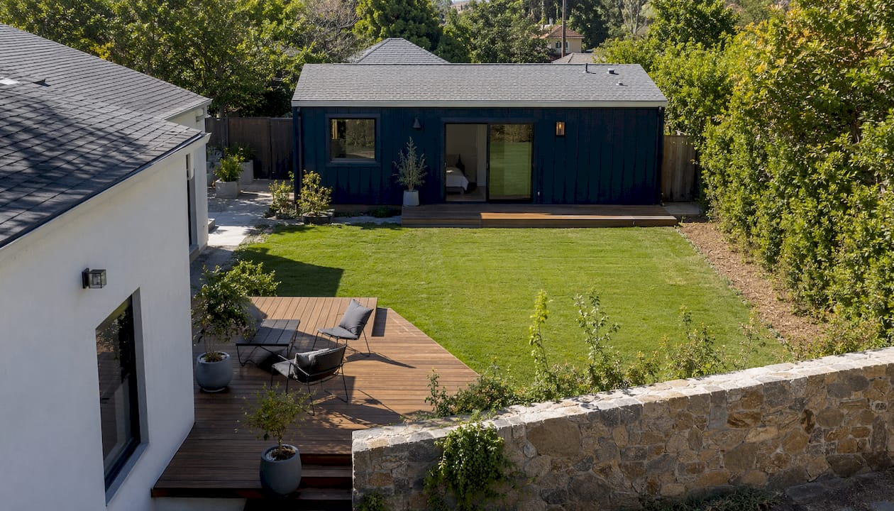 Aerial view of backyard with small ADU building