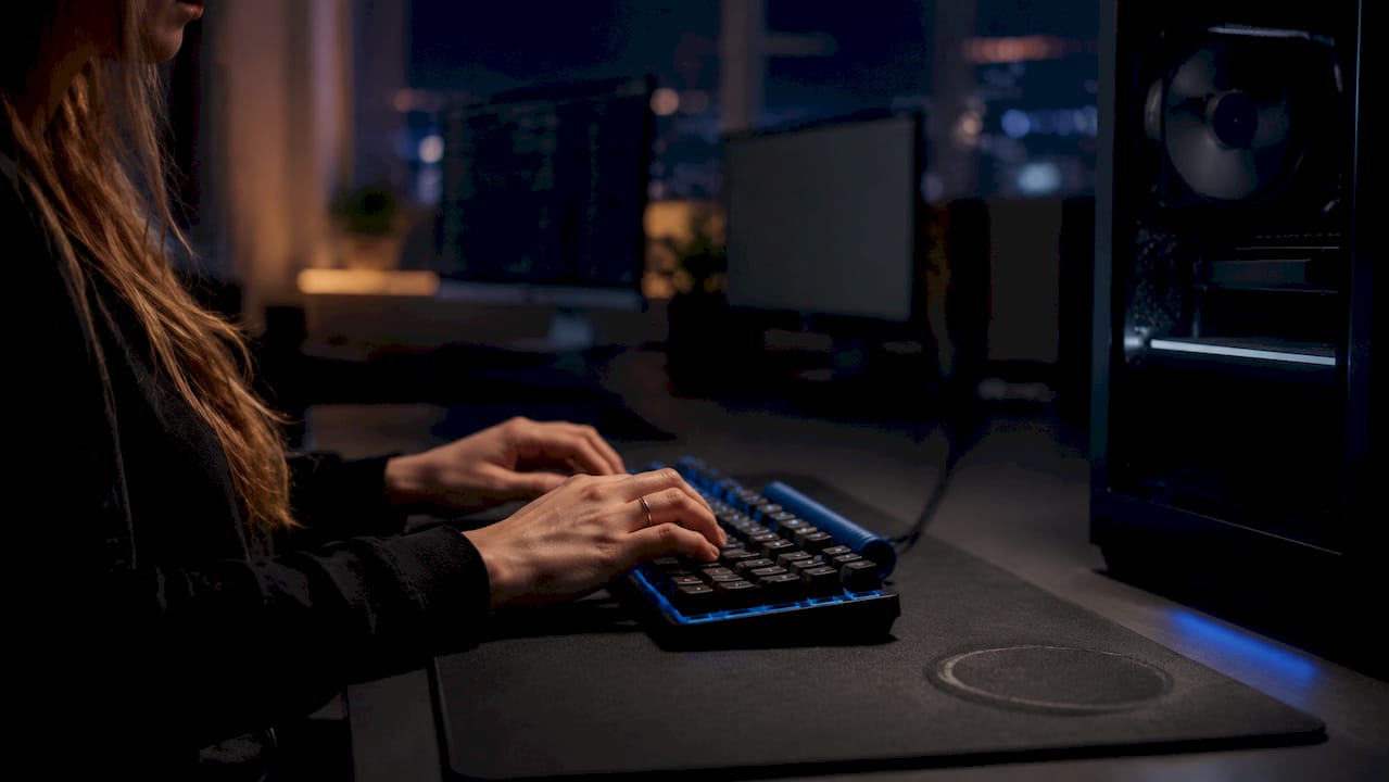 Trader hands typing next to high-performance GPU