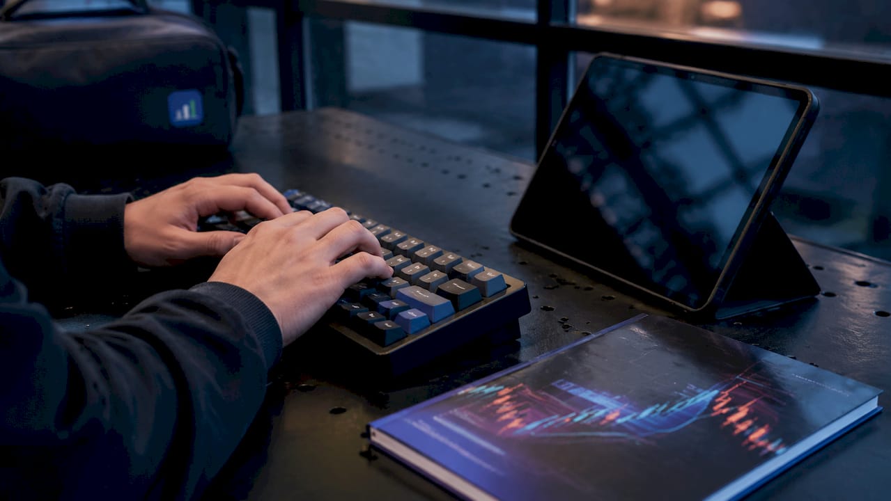 Hands typing on laptop with Ethernet cable