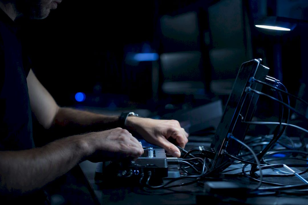 Hands connecting multiple trading devices cables