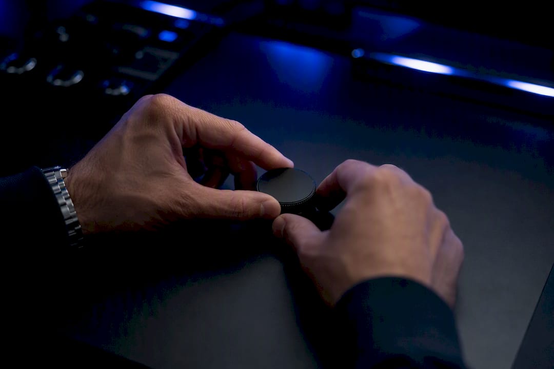 Hands adjusting risk control dial on desk