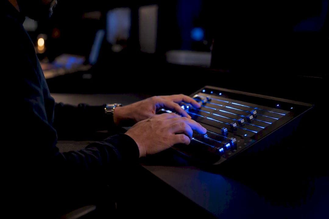 Hands adjusting controls on trading panel