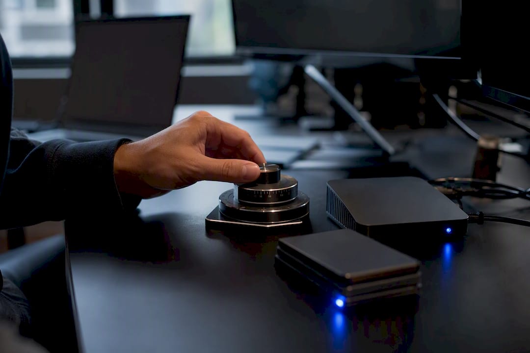 Hand adjusting analog control dial on trading desk