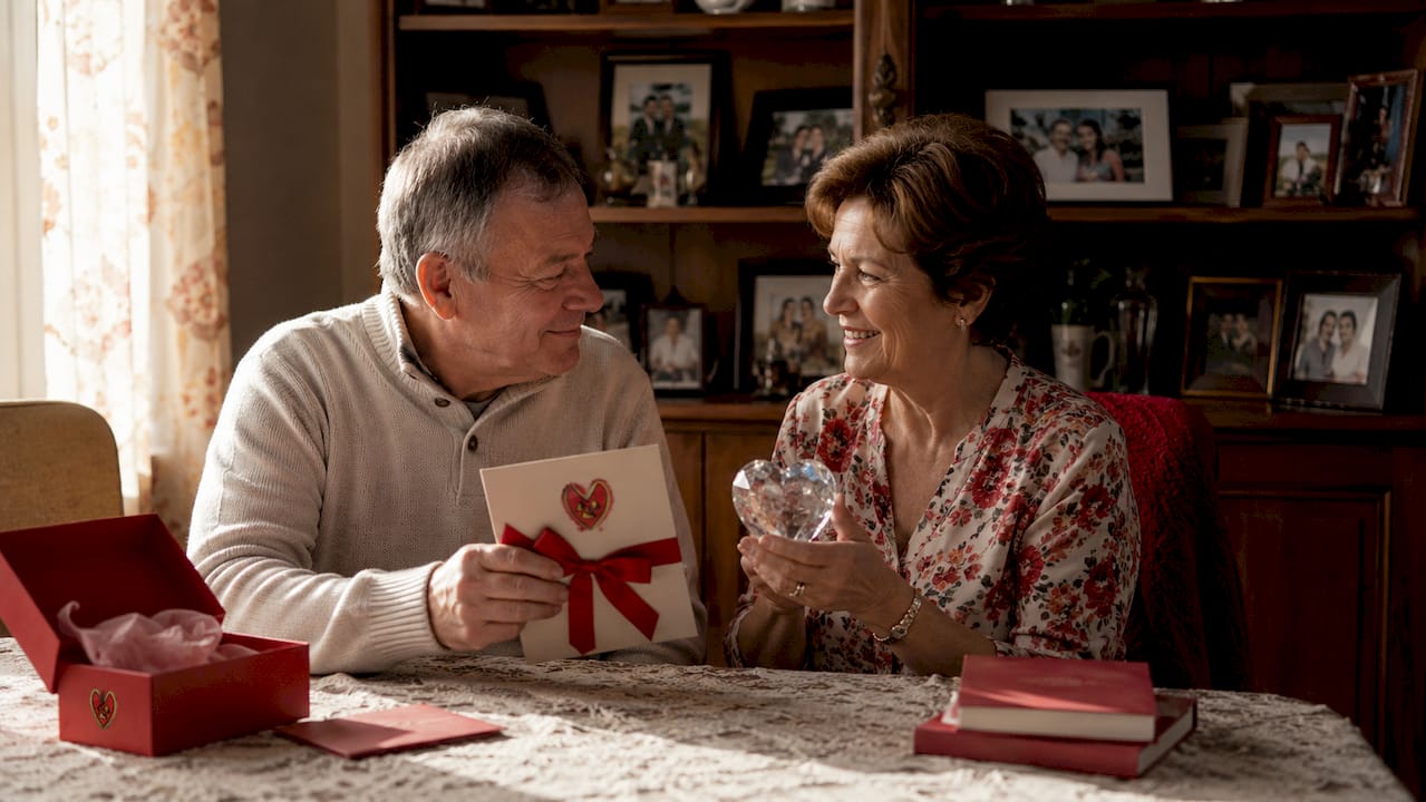 Couple exchanging traditional anniversary gifts