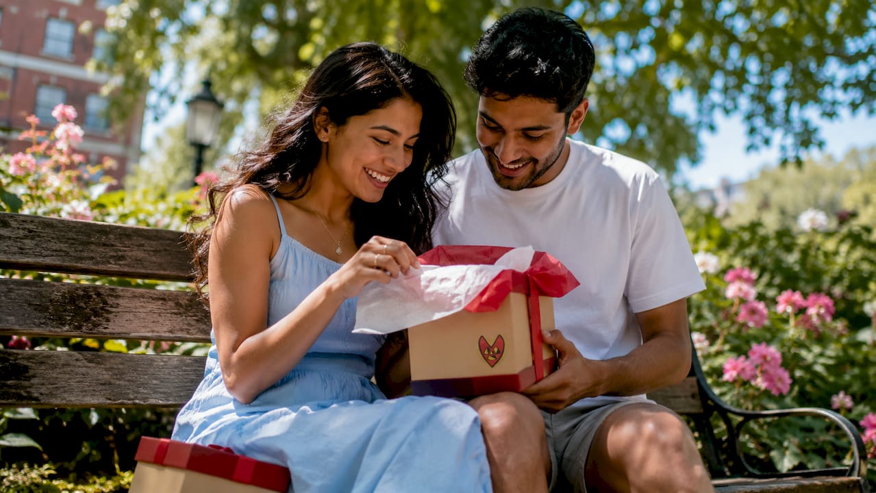 Couple sharing personalised gift in living room