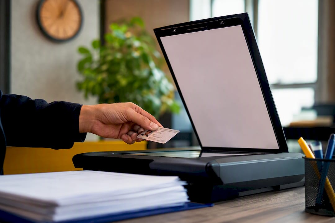 Hand scanning government ID on office scanner