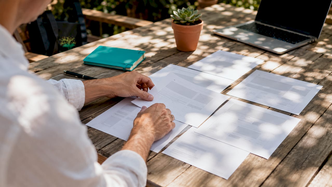 Hands organizing website page mockups
