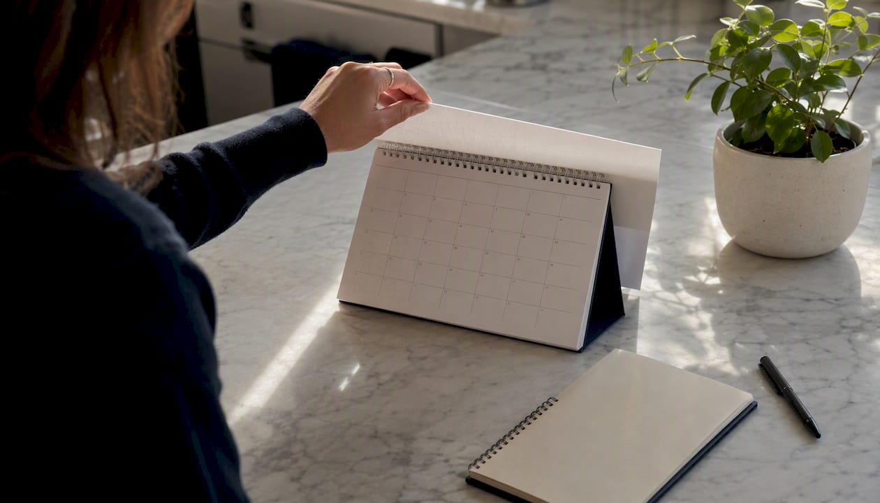 Hand flipping calendar to new quarter month
