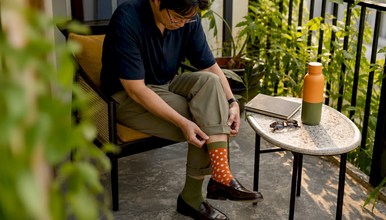 Man in office wearing bold statement socks with loafers