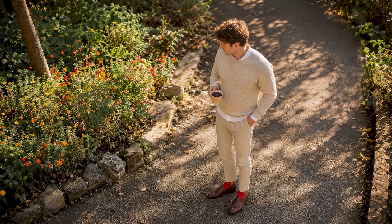 Man wearing bright red socks with loafers outdoors