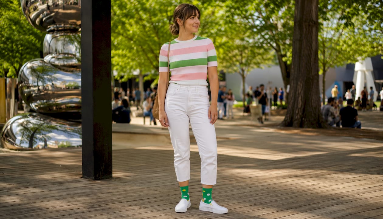 Woman showing colorful patterned socks at art gallery
