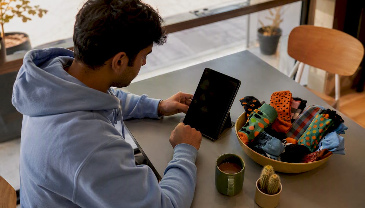 Man taking sock personality quiz at home desk