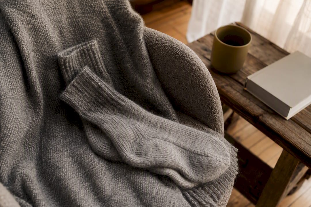 Close-up of soft cashmere socks on wool blanket