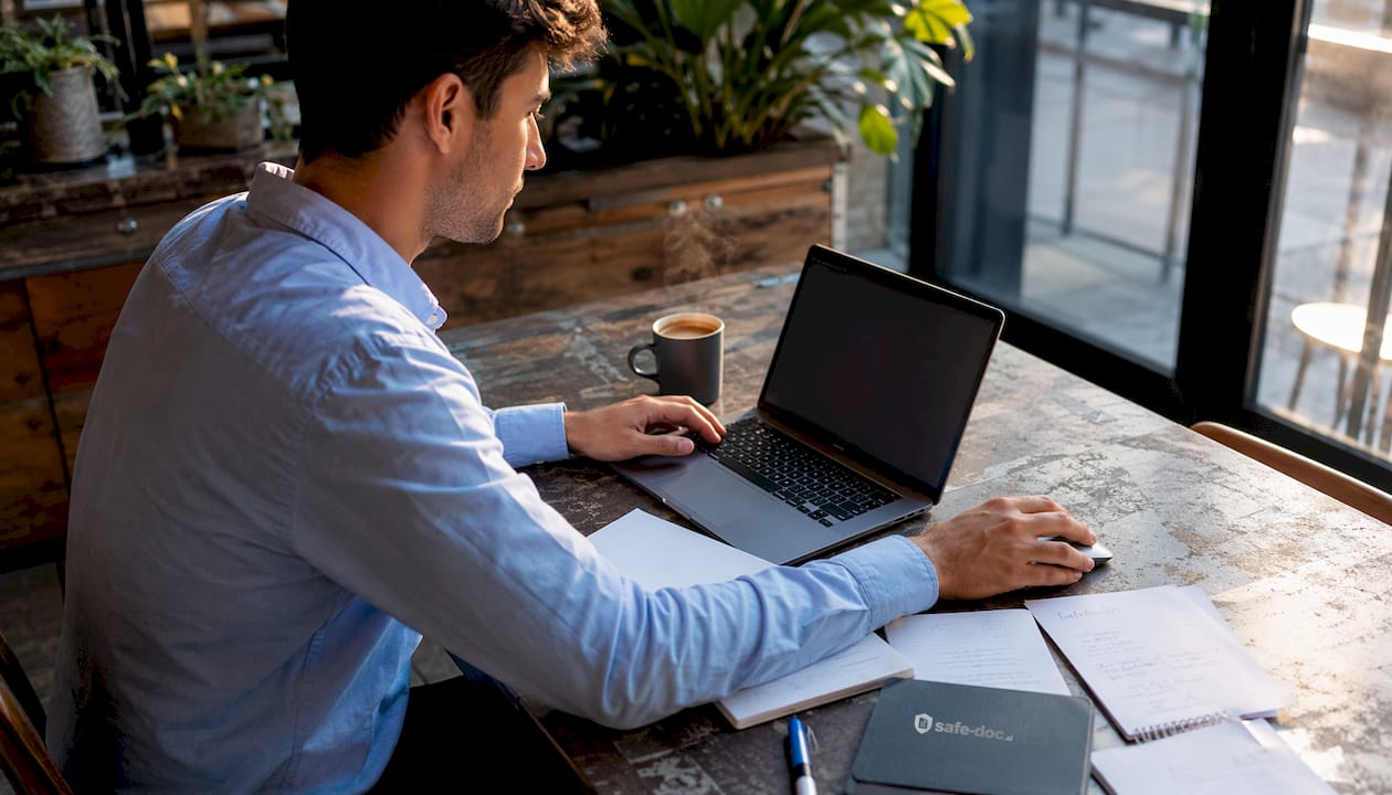 A professional analyzing financial files behind his desk.