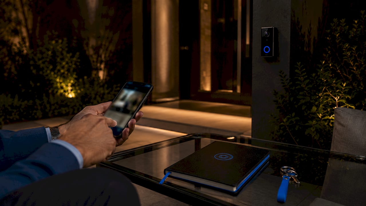Smartphone user interacting with home intercom app