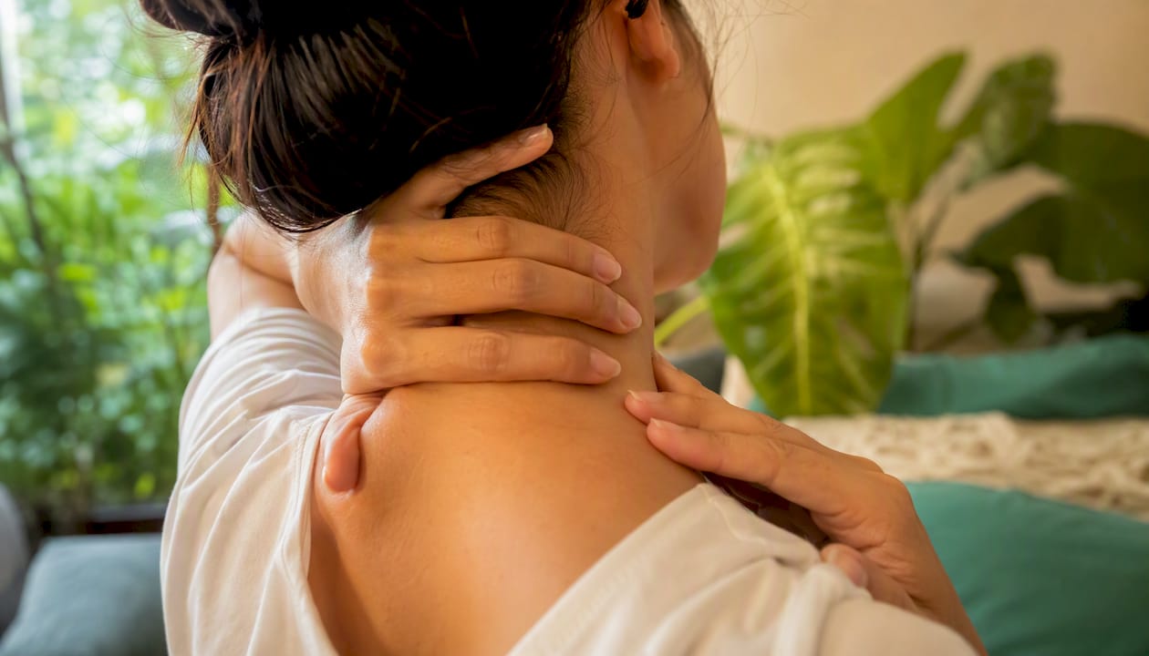 Close-up hands performing neck self-massage