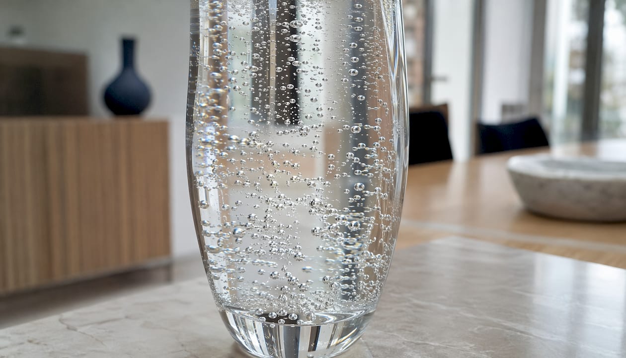 Close-up of carbonation bubbles forming in glass