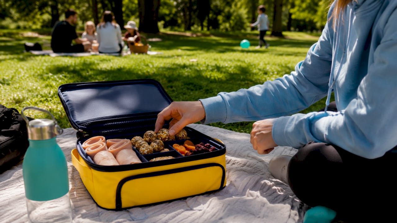 Lunchbox with grab-and-go protein snacks outdoors