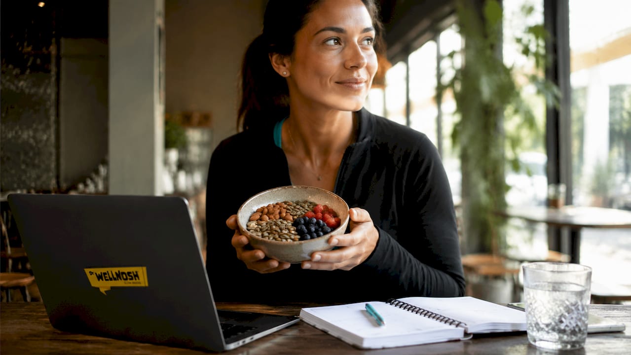 Woman preparing macro-friendly snack in kitchen