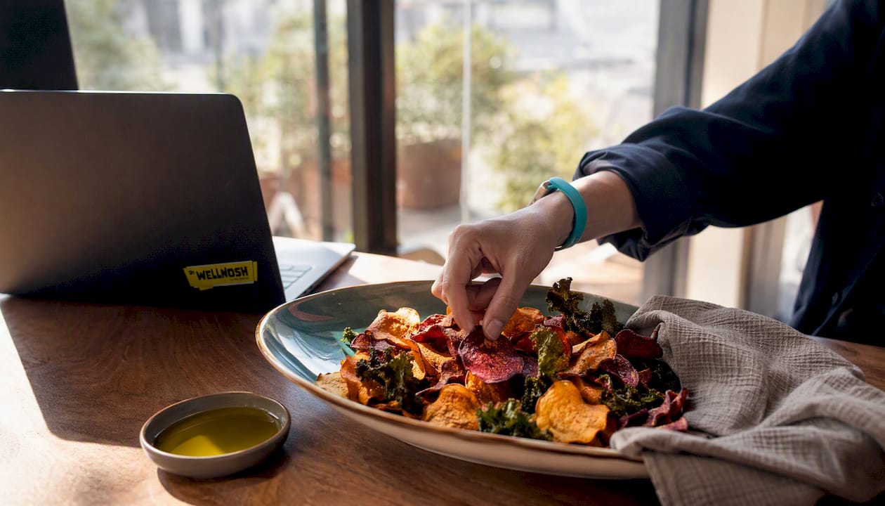 Homemade colorful root vegetable chips in wooden bowl